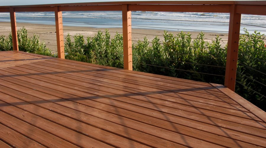 Relaxing view of the beach from a deck.